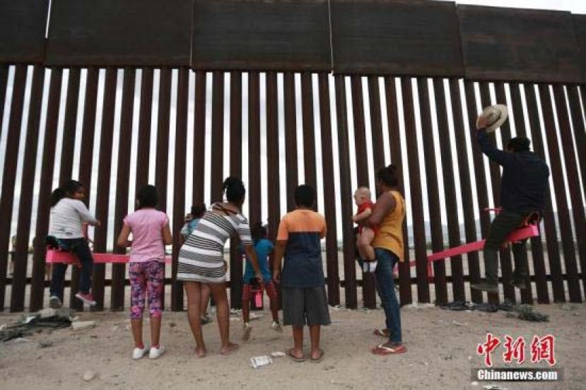 美国加州两位教授利用美墨边境高墙的空隙，设置了横跨两国的跷跷板，跷跷板一边在美国，一边则在墨西哥，让美墨两边的大人小孩隔着高墙仍能一同玩耍。