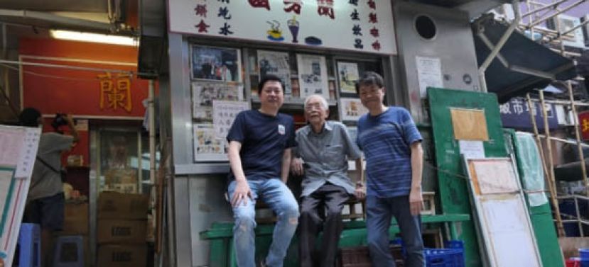 94岁林木河（中）是丝袜奶茶始祖，已将生意传给下一代，林俊业(左)与兄长（右）感情要好，一起打理茶餐厅的生意。