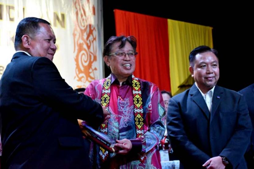 砂拉越校长理事会主席罗伯特贝达利（左）赠送纪念品予晚宴主宾砂首长拿督巴丁宜阿邦佐哈里（中）。