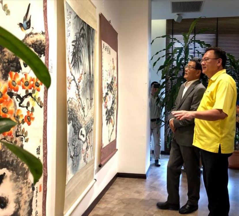 中国驻古晋总领事程广中（右二）与巴都吉当区州议员罗克强（右一）欣赏画作。