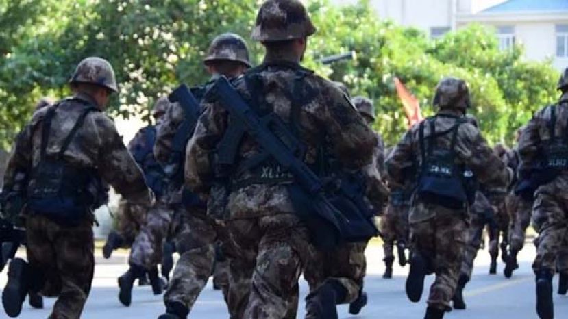 背负全副装备的士兵以连为单位，参与行军训练。